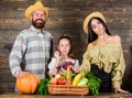 Parents and daughter celebrate harvest holiday pumpkin vegetables basket. Family rustic style farmers market with fall Royalty Free Stock Photo