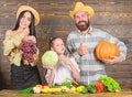 Parents and daughter celebrate harvest holiday pumpkin vegetables fruits. Family rustic style farmers market with fall Royalty Free Stock Photo