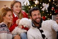 Parents with daughter and puppy making Christmas selfie Royalty Free Stock Photo