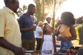 Parents and daughter at a multi generation family barbecue Royalty Free Stock Photo