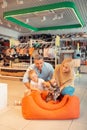 Parents and daughter playing with cat while visiting pet shop Royalty Free Stock Photo