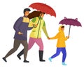 Parents and daughter spend time together on a rainy october day move down the street isolated Royalty Free Stock Photo