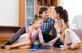 Parents and daughters with toy lotto Royalty Free Stock Photo