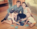 Parents and daughters with toy lotto Royalty Free Stock Photo