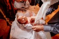 Parents dress their child on a table in the Church. the ordinance of baptism.