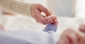 Parents, family and holding hands with baby on bed for bonding, love and relationship with infant. Adorable, cute and Royalty Free Stock Photo