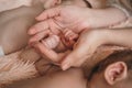 Parents gently hold small children& x27;s hands. Close-up of the baby& x27;s hand and parents. Parents care about their baby Royalty Free Stock Photo