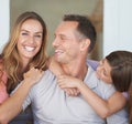 Parents, girl child and portrait on patio with hug, care and love with dad with smile at family house. Father, mother Royalty Free Stock Photo