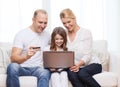 Parents and girl with laptop and credit card Royalty Free Stock Photo