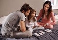 Parents, girl and playing cards to relax in home with bonding, learning and fun with strategy in bedroom. Father, mother Royalty Free Stock Photo