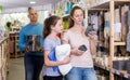 parents and girl in search of bathroom accessories