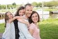 Parents Giving Children daughter girls piggybacks In Countryside