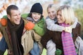 Parents giving children piggyback ride Royalty Free Stock Photo