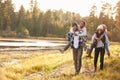 Parents Giving Children Piggyback Ride On Walk By Lake Royalty Free Stock Photo