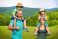 Parents giving piggyback ride to children, happy family Royalty Free Stock Photo