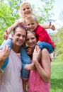 Parents giving their children piggy-back ride Royalty Free Stock Photo