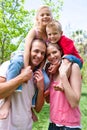 Parents giving their children piggy-back ride Royalty Free Stock Photo