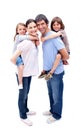 Parents giving their children a piggyback ride Royalty Free Stock Photo