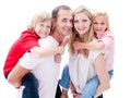 Parents giving their children piggyback ride Royalty Free Stock Photo