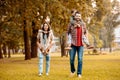 Parents giving their children a piggyback ride in an Royalty Free Stock Photo