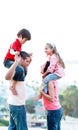 Parents giving their children piggyback rides Royalty Free Stock Photo