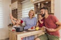 Parents having fun cooking dinner with their children Royalty Free Stock Photo