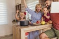 Parents having fun cooking dinner with their children Royalty Free Stock Photo