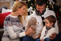 Parents having fun with son playing with teddy bear