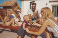 Mother feeding baby boy with watermelon slice by the pool Royalty Free Stock Photo