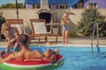 Parents having fun at the swimming pool with their children Royalty Free Stock Photo