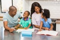 Parents helping children doing homework Royalty Free Stock Photo