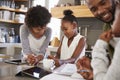 Parents Helping Children With Homework In Kitchen Royalty Free Stock Photo