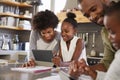 Parents Helping Children With Homework In Kitchen Royalty Free Stock Photo