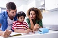 Parents helping son with homework Royalty Free Stock Photo