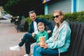 Parents with his child laughing and enjoying nature. Little cute boy eats treat Royalty Free Stock Photo