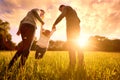 Parents hold the baby's hands. Happy family in the park evening Royalty Free Stock Photo