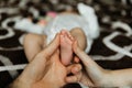 Parents hold the heel of a newborn baby baby