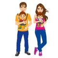 Parents holding holding their children with baby carrier Royalty Free Stock Photo