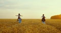 Parents walking in field with children on shoulders Royalty Free Stock Photo