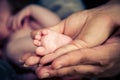 Parents holding the feet of their newborn baby Royalty Free Stock Photo