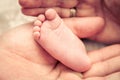 Parents holding the feet of their newborn baby Royalty Free Stock Photo