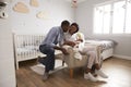 Parents Home from Hospital With Newborn Baby In Nursery Royalty Free Stock Photo
