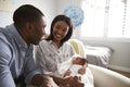 Parents Home from Hospital With Newborn Baby In Nursery Royalty Free Stock Photo