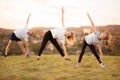 Parents instill sports habits in their child by example, focus on child. Happy sporty family doing stretching exercises, practices