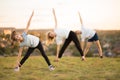 Parents instill sports habits in their child by example, focus on child. Happy sporty family doing stretching exercises