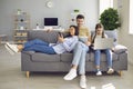 Parents and a kid child look at a laptop at their leisure in a weekend at home Royalty Free Stock Photo