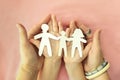 Parents and kid holding family paper cut out in hands. Celebrating International Day of Families Royalty Free Stock Photo