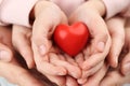 Parents and kid holding red heart in hands, closeup. Family day Royalty Free Stock Photo