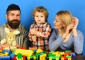 Parents and kid in playroom. Man, woman and boy Royalty Free Stock Photo