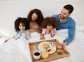 Parents, kids and breakfast in bed, morning or excited for love, bonding or care on holiday. Mother, papa and children Royalty Free Stock Photo